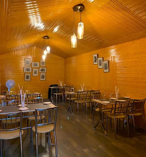 Training Restaurant & Bar, featuring wooden walls and tables.