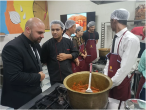 A group of men in formal attire gathered around a pot of food