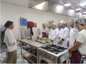 Chefs working together in a kitchen, showcasing their culinary skills around a counter