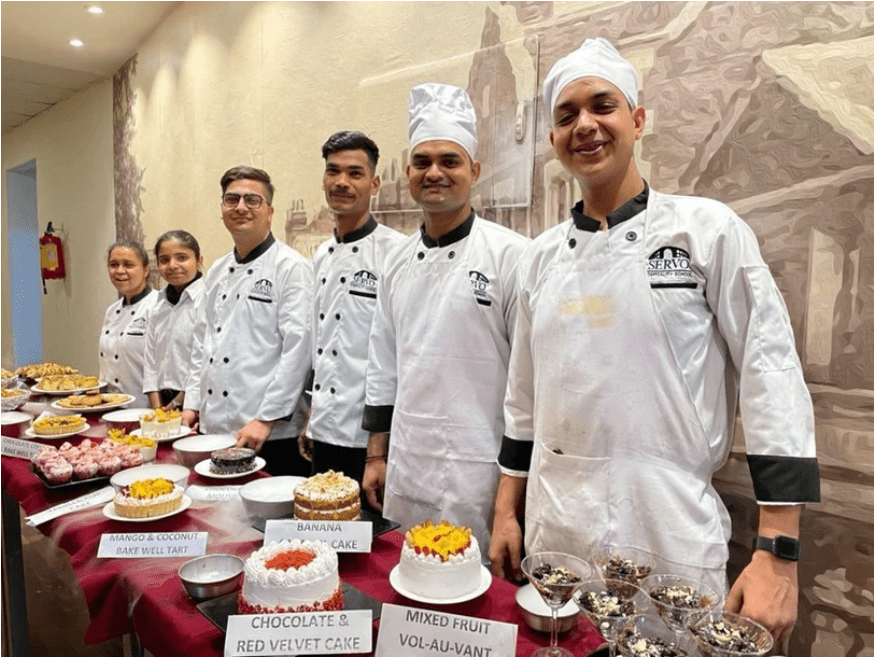 A group of chefs smiling and posing